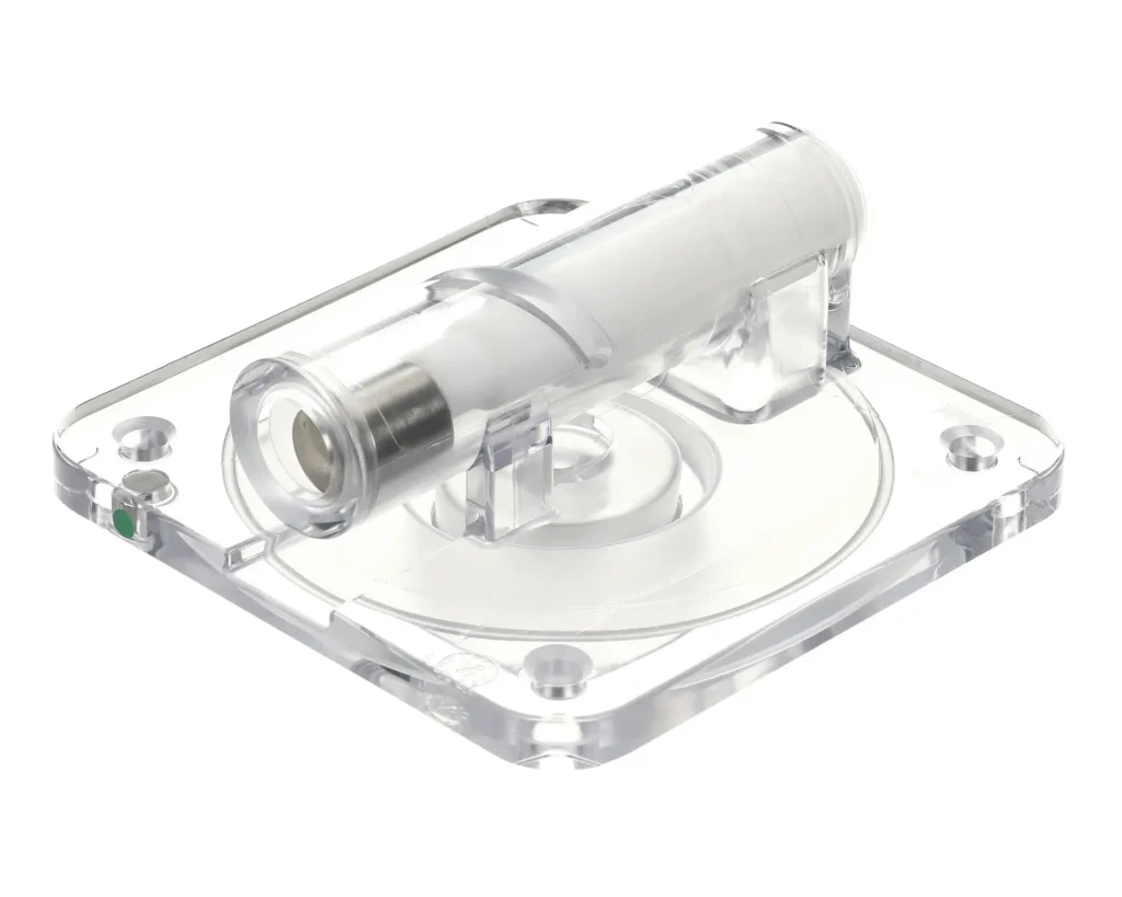 a clear plastic device with a metal tube