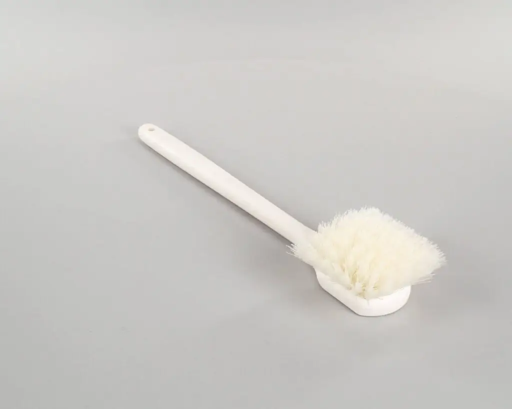 a white brush with a long handle