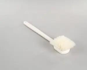a white brush with a long handle
